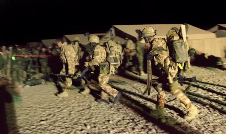 British Special Forces soldiers on a nighttime operation in Afghanistan. The image shows personnel in full combat gear moving across terrain during operations between 2010 and 2013, a period now under investigation for alleged unlawful killings. (Photo Credit: DECLASSIFIED UK)