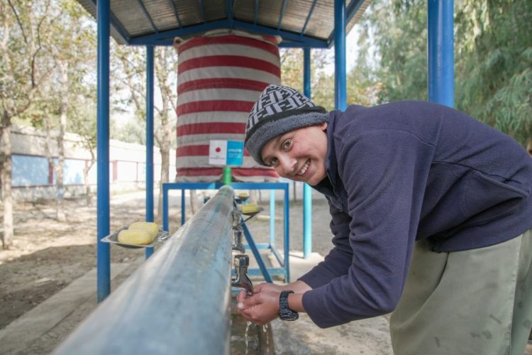 A student washes her hands at the newly installed solar-powered water supply system at a school in Kunar district, Nangarhar province, providing access to clean and safe drinking water for students. (Photo Credit: @UNICEFAfg)
