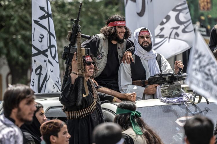 Taliban fighters celebrate in Kabul amid ongoing international concerns about security and the presence of terrorist groups in Afghanistan, despite the Taliban's denials. (Photo Credit: WAKIL KOHSAR / AFP)