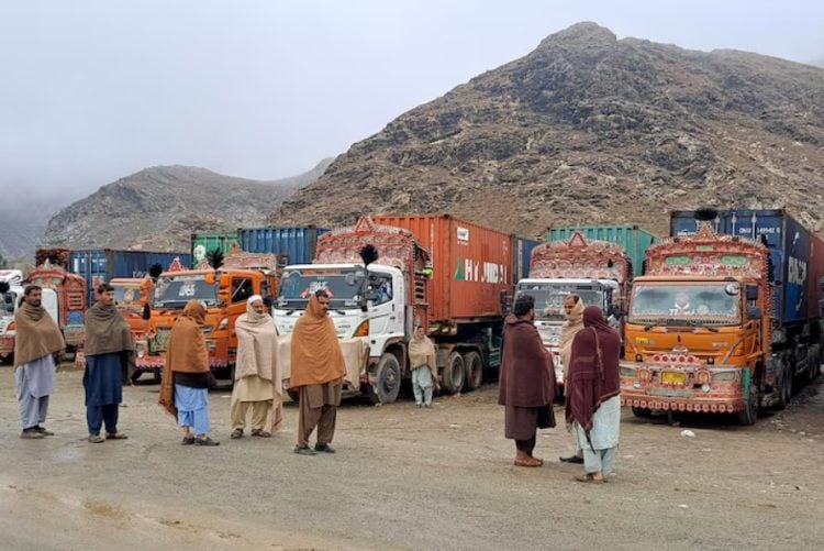 Cargo trucks and traders wait at the Afghanistan-Pakistan border crossing as the prolonged closure of the Torkham route continues to paralyze bilateral trade and trap goods worth billions of dollars. (Photo Credit: REUTERS)