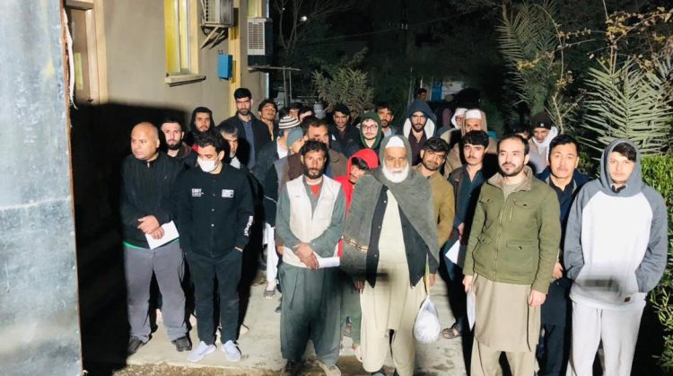 More than 250 Afghan migrants who were detained in Pakistani prisons pose for a group photo after their release and return to Afghanistan via the Spin Boldak border crossing. (Photo Credit: @MoRRAfg)