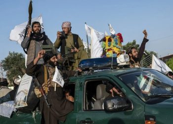 Taliban fighters celebrate on a truck displaying their flags in Afghanistan, symbolizing their return to power after decades of ideological conflict in the country. (Photo Credit: AFP)