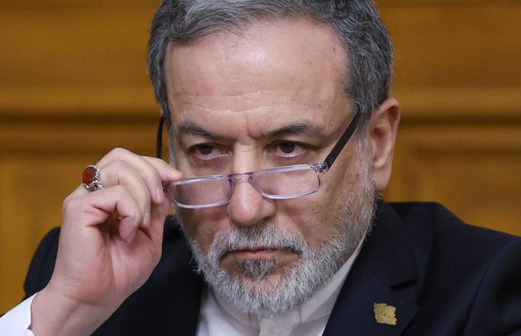 Iran's Foreign Minister Abbas Araghchi discusses diplomatic efforts to prevent military confrontation with the United States while emphasizing Iran's readiness for potential conflict. (Photo Credit: RAMIL SITDIKOV / POOL / AFP)