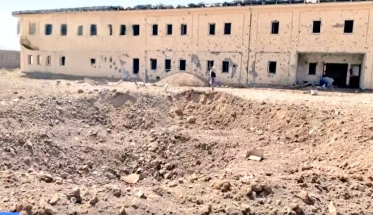 A bomb crater and bullet-riddled building in Kandahar's Takhta Pol area following reported Pakistani airstrikes on civilian areas, including a refugee camp. (Photo Credit: @FitratHamd)