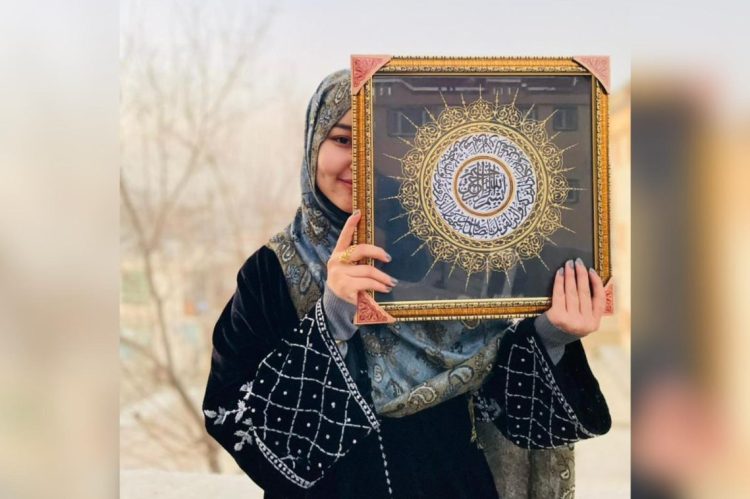 Afghan artist Shabnam, known by her artist name Sarabi, proudly holds one of her intricate calligraphy paintings, a testament to the enduring hope and creativity of Afghan women who refuse to let their dreams be silenced. (Photo Credit: Exclusive)