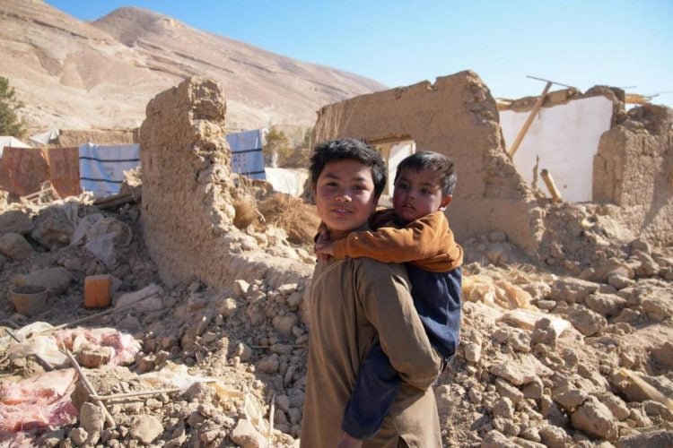Two children stand amid the ruins of their home in Afghanistan, where millions require urgent humanitarian assistance and access to healthcare and education services. (Photo Credit: https://x.com/TajudeenOyewale)