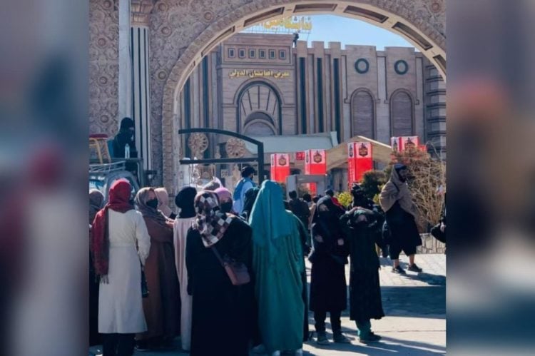 Women gathered outside the Afghanistan International Exhibition Center gates in Kabul after being barred from the "Construction and Reconstruction" exhibition, where Taliban authorities prevented them from showcasing or selling their handicrafts and goods. (Photo Credit: Afghanistan International)