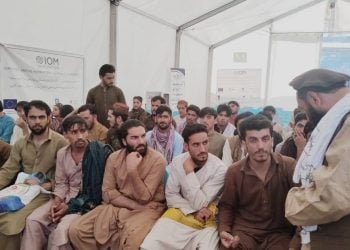 Afghan migrants who were recently released from Pakistani prisons are seen at an IOM First Arrival Humanitarian Assistance point at the Spin Boldak crossing, following their return to Afghanistan on March 12, 2025. (Photo Credit: @MoRRAfg)