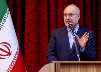 Mohammad Bagher Ghalibaf speaks at a podium with the Iranian flag in the background. (Photo Credit: Press TV)