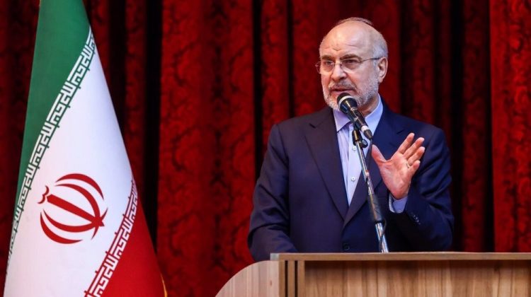 Mohammad Bagher Ghalibaf speaks at a podium with the Iranian flag in the background. (Photo Credit: Press TV)