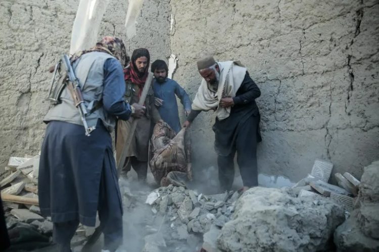 Men dig through rubble to retrieve victims after Pakistani airstrikes targeted civilian homes in Nangarhar province, Afghanistan. (Photo Credit: AFP)