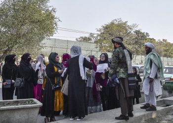 Women in Afghanistan confront Taliban fighters on the street, holding papers in a rare act of public defiance against the regime's sweeping restrictions on their fundamental rights. (Photo Credit: AFP)