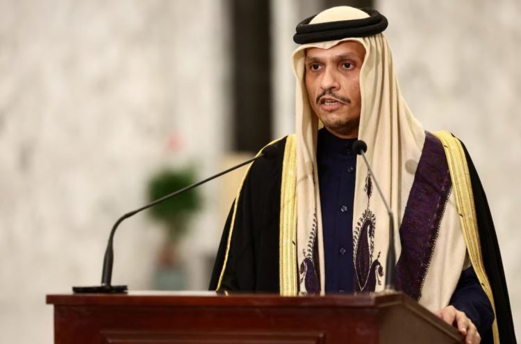 Qatari Prime Minister Sheikh Mohammed bin Abdulrahman al-Thani speaks at a podium, urging diplomatic de-escalation amid rising tensions following coordinated US-Israeli strikes on Iran. (Photo Credit: Reuters)