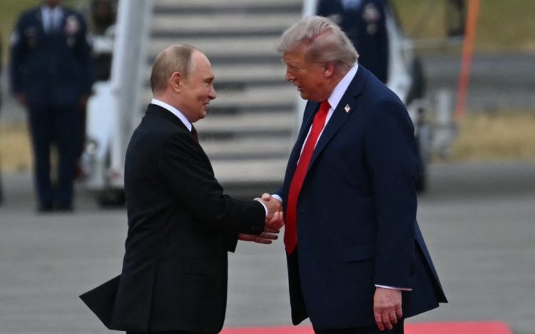 U.S. President Donald Trump and Russian President Vladimir Putin shake hands at a summit, as both leaders discussed ongoing conflicts in Ukraine and Iran. (Photo Credit: AFP)