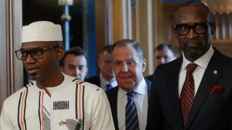 Sadio Camara with Russian officials (Photo Credit: BBC)