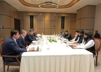 Afghan and Uzbek delegations discuss counter-narcotics cooperation during meeting around a table. (Photo Credit: @bnadari1)