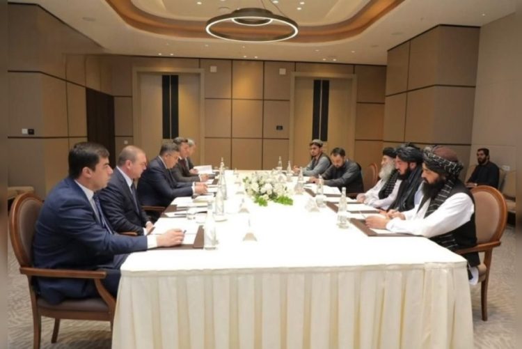 Afghan and Uzbek delegations discuss counter-narcotics cooperation during meeting around a table. (Photo Credit: @bnadari1)