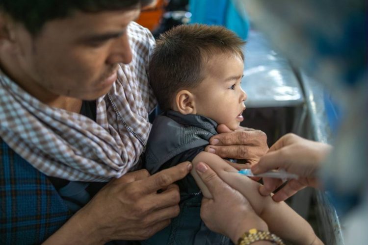 A child receiving a measles vaccination during a public health immunization campaign. (Photo Credit: UNICEF)