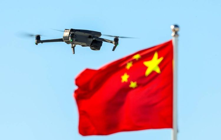 Chinese drone flying over waving Chinese flag (Photo Credit: TASS)