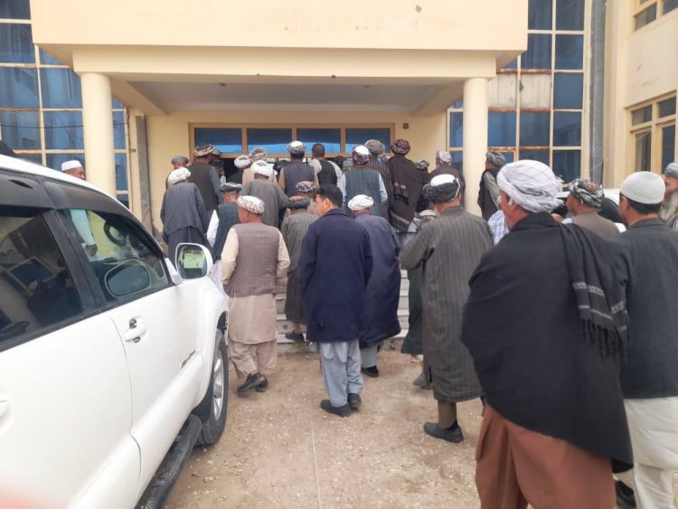 A crowd of residents gathers outside the provincial office in Faryab to protest ID distribution to Kuchi nomads. (Photo Credit: Uzbek TV)