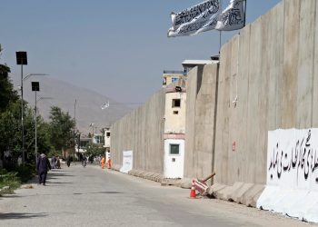 A long concrete blast wall blocks movement in Kabul, highlighting security concerns. (Photo Credit: AFP)
