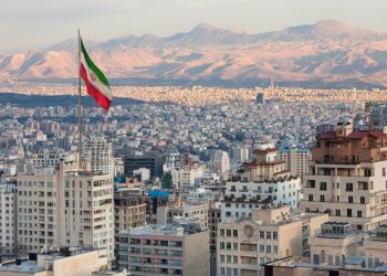 Tehran skyline with Iran flag (Photo Credit: istock / BornaMir)
