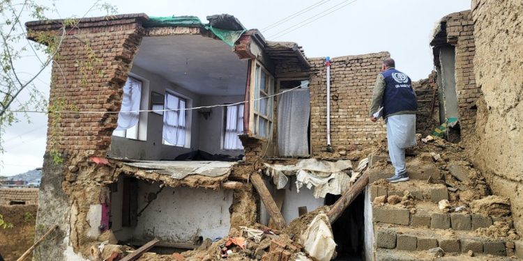 A UN-Habitat official inspects a severely damaged residential building in Afghanistan following devastating floods that destroyed hundreds of homes across multiple provinces. (Photo Credit: @UNHabitatAf)