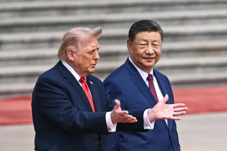 U.S. President Donald Trump and Chinese President Xi Jinping speak during a meeting in Beijing. (Photo credit: Bloomberg)