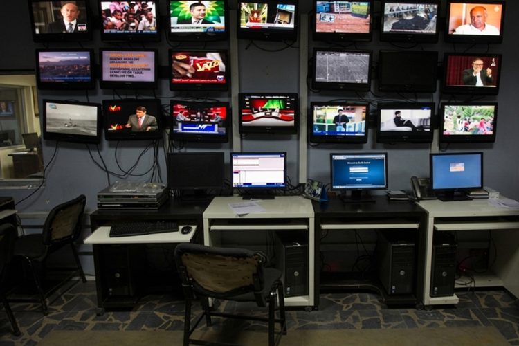 A media monitoring room displays multiple television channels broadcasting simultaneously, reflecting the shrinking space for independent and diverse content on Afghanistan's airwaves. (Photo credit: AFJC)