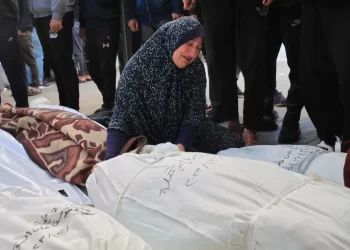 A Palestinian woman weeps over the shrouded bodies of her loved ones killed in Israeli strikes on Gaza, as the war's death toll surpasses 72,000. (Photo Credit: AFP)