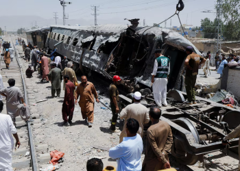 Rescue workers and bystanders survey the wreckage of a bombed train in Quetta, Balochistan, after a deadly explosion killed at least 24 people. (Photo credit: Reuters)