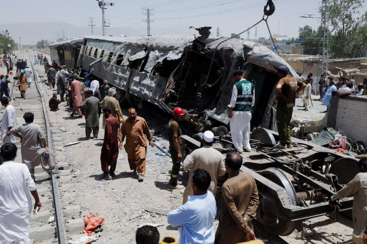 Rescue workers and bystanders survey the wreckage of a bombed train in Quetta, Balochistan, after a deadly explosion killed at least 24 people. (Photo credit: Reuters)