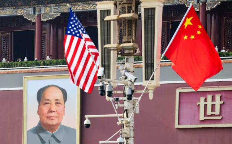 US and Chinese flags are seen flying near a portrait of former Chinese leader Mao Zedong in Beijing, ahead of US President Donald Trump’s visit to China. (Photo credit: Reuters)