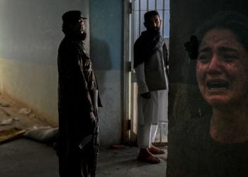 Armed Taliban members stand inside a detention facility as a distressed woman weeps, illustrating the fear and abuse documented in the UN Security Council's latest report on sexual violence in Afghanistan. (Photo credit: Freepik / AFP)