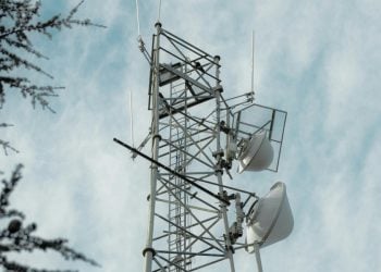 A telecommunications tower stands against a cloudy sky as residents in Balkh province report sharp price hikes and shrinking services from telecom companies. (Photo Credit: Pexels)