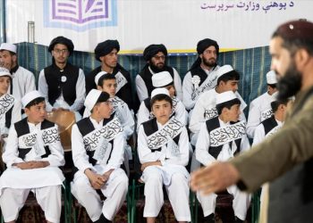 Students attend a public school ceremony under a banner of the Taliban-run caretaker Ministry of Education in Afghanistan. (Photo Credit: AFP)
