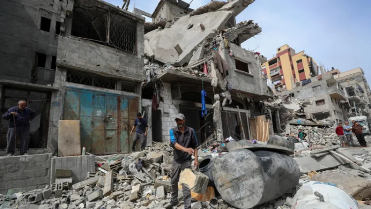 In this image, the destruction left by the war in the Gaza Strip is visible, and several men can be seen among the rubble and ruins. (Photo Credit: Reuters)