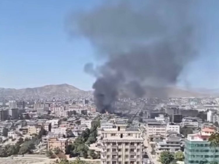 Thick smoke is rising into the sky from behind the buildings. (Photo credit: Social media)
