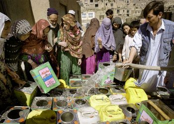 Residents crowd around a water distribution point in Kabul, filling repurposed containers and jerry cans as the city's water crisis deepens. (Photo credit: AFP)