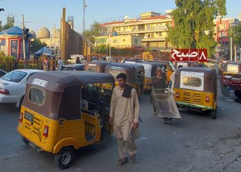 Rickshaw drivers and their vehicles crowd a busy street in Nangarhar as the Taliban's sweeping ban threatens to strip thousands of their only source of livelihood. (Photo credit: 8am.media)