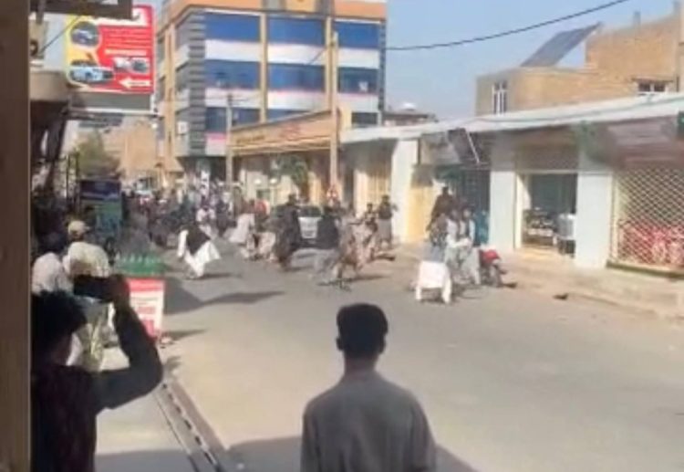 Taliban fighters confront protesters on a street in Herat's Jibrail district after opening fire on demonstrators protesting the detention of women and girls. (Photo Credit: Exclusive)
