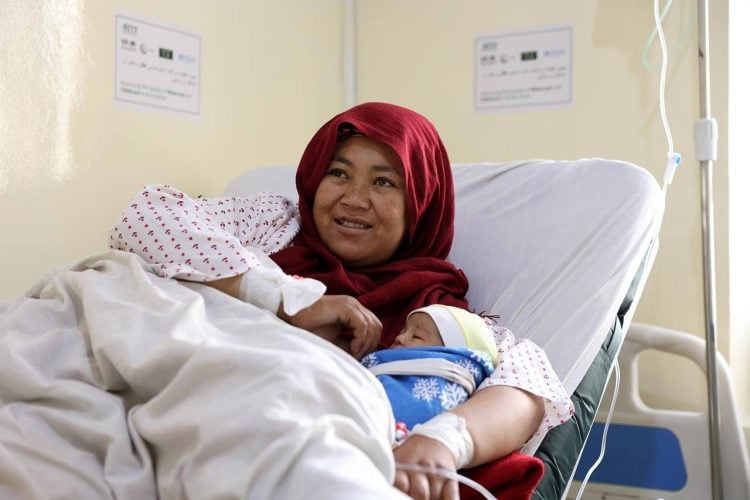 A newborn rests in its mother’s arms, symbolizing the importance of safe childbirth and maternal health services. (Photo credit: WHO)