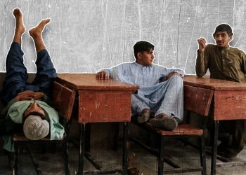Students lean back and rest at their desks in an Afghanistan classroom, as debates continue over the country's shifting education system. (Photo credit: Exclusive)