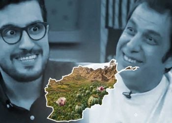 An illustration overlays a poppy field onto Afghanistan's outline as two men react with amusement in the background. (Photo credit: Social Media)