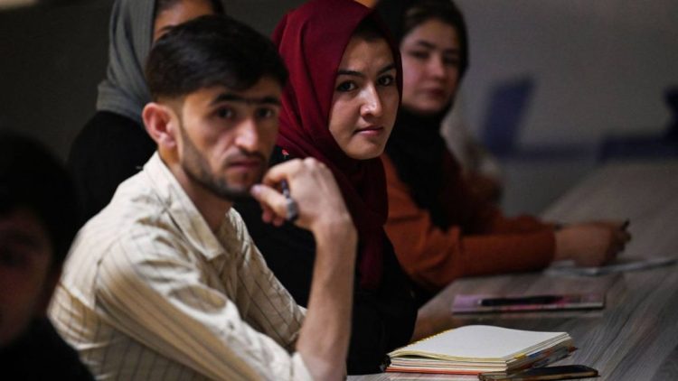 Students attend a classroom session as young people in Afghanistan seek greater access to education and opportunities. (Photo credit: AFP)