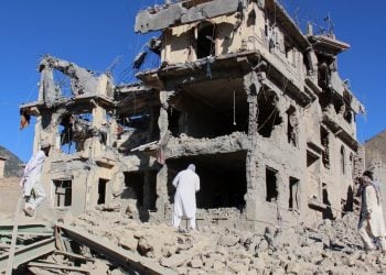 Residents inspect the ruins of a bombed multi-story home in Kunar province following border clashes between the Taliban and Pakistan. (Photo credit: AP)