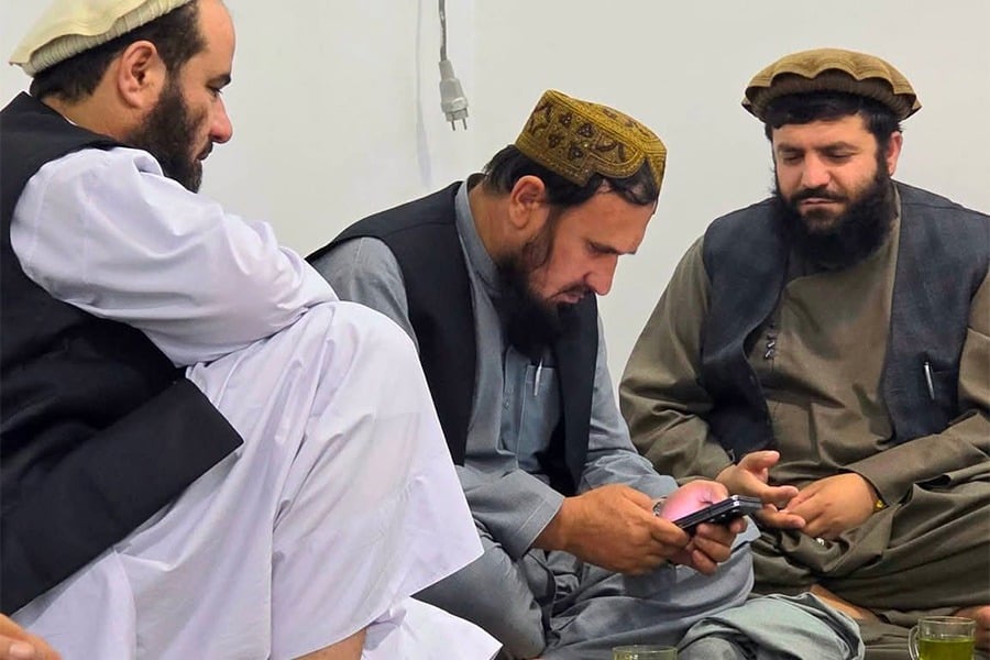 Taliban figures Fasihuddin Fitrat (center) and Jumma Khan Fateh (right), along with another member, are seen during an informal gathering. (Photo credit: Exclusive)