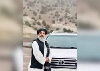 Haji Abdulkhaliq Noorzai, a tribal elder from Nimroz, stands beside his car before being killed in an armed attack in Zaranj city. (Photo credit: Social Media)
