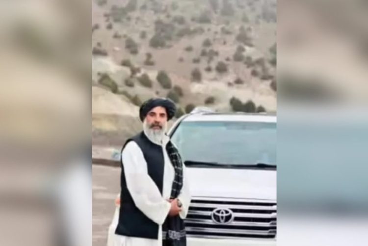 Haji Abdulkhaliq Noorzai, a tribal elder from Nimroz, stands beside his car before being killed in an armed attack in Zaranj city. (Photo credit: Social Media)