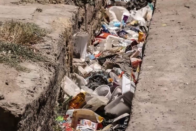 Household waste piles up inside a roadside drainage channel in Herat amid a shortage of garbage bins across the city. (Photo credit: Exclusive)